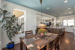 Dining room featuring wooden ceiling and dark wood-style flooring