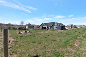View of grassy yard featuring a mountain view