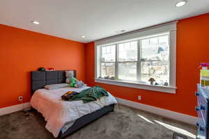 Carpeted bedroom with recessed lighting and baseboards