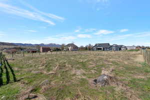 View of yard featuring a view of countryside and a mountain view