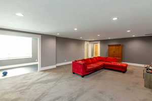 Living area featuring light carpet and recessed lighting