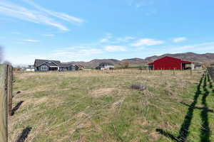 View of yard with a mountain view, an outbuilding, and an outdoor structure