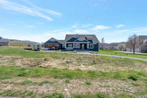 View of front of home with a mountain view and a garage