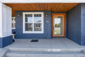 View of exterior entry featuring a porch