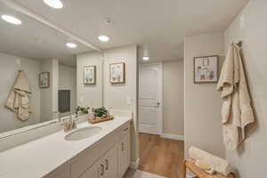 Bathroom featuring vanity, recessed lighting, and light wood finished floors
