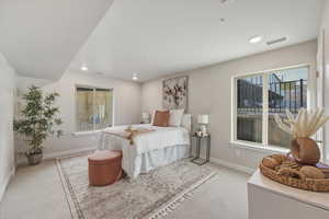 Bedroom featuring light carpet and recessed lighting