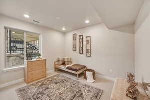 Sitting room featuring light colored carpet and recessed lighting