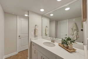 Bathroom featuring vanity, recessed lighting, and light wood finished floors