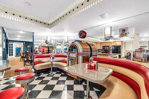 Dining area featuring crown molding and light flooring