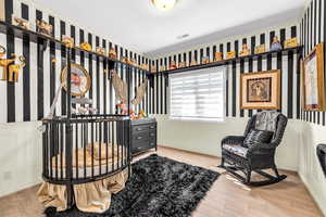 Walk in closet with light wood-style flooring