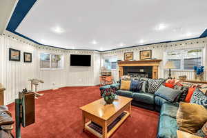 Living area featuring plenty of natural light, carpet flooring, ornamental molding, and recessed lighting