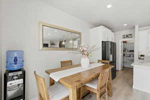 Dining room with recessed lighting and light wood-style floors