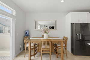 Dining space featuring light wood-type flooring and recessed lighting