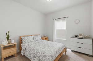 Bedroom with light colored carpet