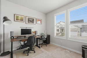 Office featuring light carpet and baseboards