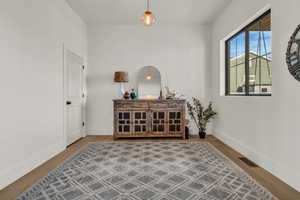 Sitting room with wood finished floors and baseboards