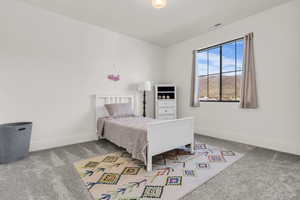 Bedroom featuring light colored carpet and baseboards