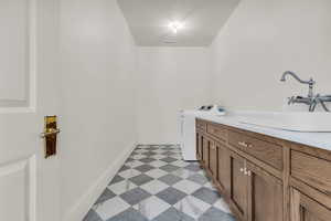 Bathroom featuring vanity and washing machine and dryer