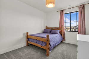 Carpeted bedroom featuring baseboards