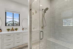 Full bath featuring a shower stall and vanity