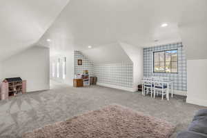 Additional living space with carpet floors and recessed lighting