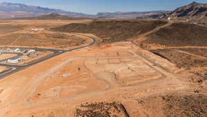 Aerial view of property and surrounding area featuring mountains and rural landscape