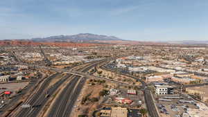 Drone / aerial view of a mountain backdrop and a highway