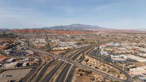 Drone / aerial view of a mountain backdrop and a main thoroughfare