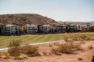 Back of house featuring a mountain view and a residential view
