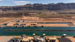 Aerial view of property's location featuring a water and mountain view and a desert landscape