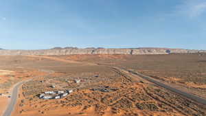 Aerial view of sparsely populated area with a desert landscape and a mountainous background