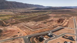 Aerial view of property and surrounding area featuring a mountain backdrop and rural landscape