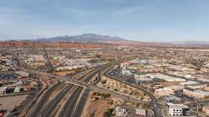 Drone / aerial view of a mountain backdrop and a major roadway