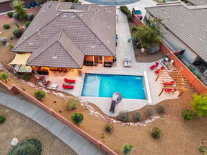 View of swimming pool with patio surround and a fenced backyard