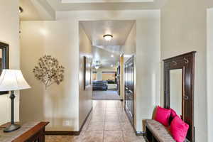 Corridor with baseboards and light stone finish flooring