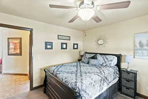 Bedroom featuring ceiling fan and light carpet