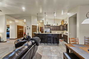 Living room featuring a high ceiling and light tile patterned flooring