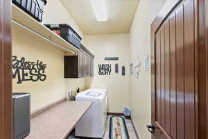 Laundry area featuring cabinet space and washer and clothes dryer