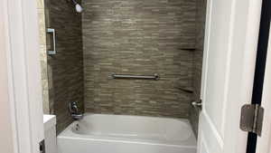 Bathroom with shower / bath combination and vanity