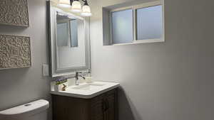 Half bath featuring vanity and toilet