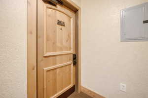 View of exterior entry with electric panel