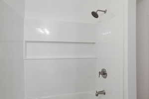 Bathroom view of washtub / shower combination