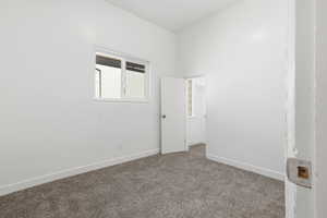 Unfurnished room with baseboards and carpet floors