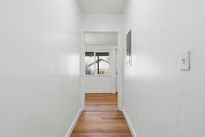 Hallway featuring light wood-style floors and electric panel