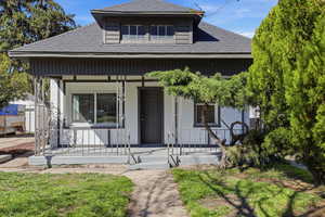 Bungalow-style house featuring covered porch and a shingled roof