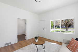 Living area featuring light wood-style flooring and baseboards