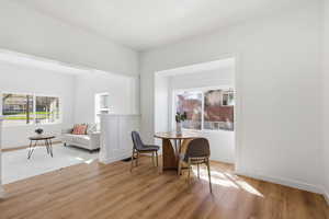 Dining area with light wood-type flooring and baseboards