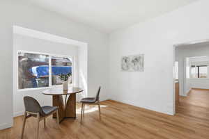 Dining space featuring baseboards and light wood finished floors