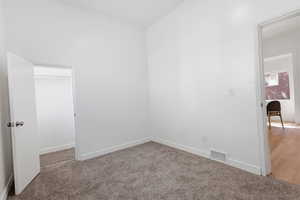 Spare room featuring baseboards and carpet floors