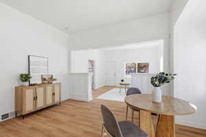 Dining area with light wood-style flooring and baseboards